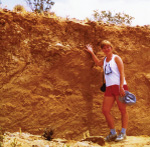 a person standing in front of a 6 foot fault scarp